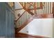 Elegant foyer with hardwood floors, a wooden staircase, and decorative iron railings at 1627 Leguin Mill Rd, Locust Grove, GA 30248