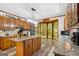 Spacious kitchen featuring wood cabinets, granite countertops, an island, and a breakfast nook with great views at 1627 Leguin Mill Rd, Locust Grove, GA 30248