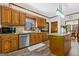 Well-designed kitchen with modern appliances, wood cabinets, granite countertops, and breakfast bar at 1627 Leguin Mill Rd, Locust Grove, GA 30248
