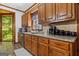 Traditional kitchen with granite countertops, stone backsplash, wood cabinets, and stainless steel appliances at 1627 Leguin Mill Rd, Locust Grove, GA 30248