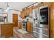 Spacious kitchen features stainless steel appliances, wood cabinetry, and island at 1627 Leguin Mill Rd, Locust Grove, GA 30248