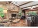 Cozy living room with a stone fireplace, wood floors, and comfortable leather seating at 1627 Leguin Mill Rd, Locust Grove, GA 30248