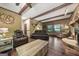 Spacious living room with wooden beamed ceilings, stone fireplace and a hardwood floor at 1627 Leguin Mill Rd, Locust Grove, GA 30248