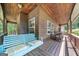 Cozy porch featuring a wooden ceiling, swinging bench and classic rocking chairs at 1627 Leguin Mill Rd, Locust Grove, GA 30248