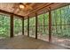 Relaxing screened porch with wood ceiling and views to private wooded backyard at 1627 Leguin Mill Rd, Locust Grove, GA 30248