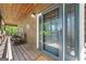 Inviting covered porch featuring a wooden ceiling, rocking chairs, and a glass-paneled door at 1627 Leguin Mill Rd, Locust Grove, GA 30248