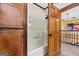 Shower stall with built-in shelves and a view of the staircase at 1627 Leguin Mill Rd, Locust Grove, GA 30248