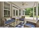 Comfortable seating area on the covered patio, perfect for enjoying the outdoors with view to the backyard at 465 Crabapple Rd, Fayetteville, GA 30215