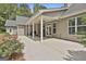Expansive back patio with gray siding and outdoor seating, ideal for relaxation and enjoying the landscaped backyard at 465 Crabapple Rd, Fayetteville, GA 30215