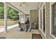 Covered back patio featuring outdoor furniture, ceiling fan, and access to the well-maintained backyard and playset at 465 Crabapple Rd, Fayetteville, GA 30215