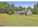 Sprawling backyard featuring a lush lawn, mature trees, and a patio area, perfect for outdoor enjoyment at 465 Crabapple Rd, Fayetteville, GA 30215