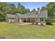 View of a backyard, patio, and covered porch with lovely landscaping at 465 Crabapple Rd, Fayetteville, GA 30215