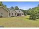 Well-maintained backyard with lawn, landscaping, and covered porch of this lovely home at 465 Crabapple Rd, Fayetteville, GA 30215