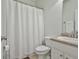 Clean bathroom featuring a shower with curtain, white fixtures, and ample lighting at 465 Crabapple Rd, Fayetteville, GA 30215