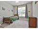 Comfortable bedroom features a twin bed, neutral walls, large window, and plush carpeting at 465 Crabapple Rd, Fayetteville, GA 30215