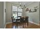 Bright dining area features a chandelier, wood floors, a view of the backyard, and space for four at 465 Crabapple Rd, Fayetteville, GA 30215