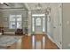 Open foyer with hardwood floors, decorative lighting, and stylish decor creates an inviting entrance at 465 Crabapple Rd, Fayetteville, GA 30215