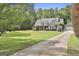Charming home with a well-manicured lawn, mature trees, and a long driveway at 465 Crabapple Rd, Fayetteville, GA 30215