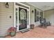 Cozy porch with comfortable rocking chairs, potted plants, and a welcoming entrance exudes relaxation at 465 Crabapple Rd, Fayetteville, GA 30215