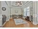 Bright living room with hardwood floors, a ceiling fan, and stylish decor provides a comfortable space at 465 Crabapple Rd, Fayetteville, GA 30215