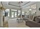 This open living room features a stone fireplace, plush seating, and direct access to an eat-in kitchen at 465 Crabapple Rd, Fayetteville, GA 30215