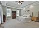 Light-filled main bedroom features a tray ceiling, soothing color palette, and picture window views at 465 Crabapple Rd, Fayetteville, GA 30215