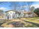 Back exterior showing two-story design, chimney, and a deck with plenty of backyard lawn at 2511 Due West Nw Cir, Kennesaw, GA 30152