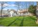 Back exterior showcasing a deck, mature trees, and lawn, perfect for outdoor activities at 2511 Due West Nw Cir, Kennesaw, GA 30152