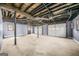 Spacious basement with exposed ceiling and multiple garage doors at 2511 Due West Nw Cir, Kennesaw, GA 30152