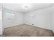 Bright bedroom with neutral carpet, two windows, textured ceilings, and plenty of natural light at 2511 Due West Nw Cir, Kennesaw, GA 30152