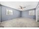Spacious bedroom with two large windows, ceiling fan, neutral carpet, and freshly painted walls at 2511 Due West Nw Cir, Kennesaw, GA 30152
