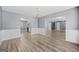 Open dining room with hardwood floors, modern lighting, and views to the kitchen and living spaces at 2511 Due West Nw Cir, Kennesaw, GA 30152