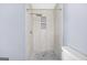Updated bathroom features a tiled walk-in shower with rainfall shower head and shelving at 2511 Due West Nw Cir, Kennesaw, GA 30152