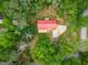 Aerial shot of a house nestled among trees, boasting a red roof and a spacious backyard at 428 Cornish Mountain Rd, Oxford, GA 30054