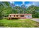 Single-Gathering ranch style home with a red metal roof and an inviting porch with lush green surroundings at 428 Cornish Mountain Rd, Oxford, GA 30054