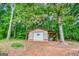 View of the outbuilding with weathered siding and covered carport at 428 Cornish Mountain Rd, Oxford, GA 30054