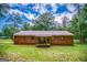 Exterior rear view of the brick home featuring a metal roof and small porch at 428 Cornish Mountain Rd, Oxford, GA 30054