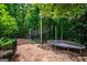 The lush backyard boasts a trampoline, treehouse and play area at 125 High Bluff Trl, Carrollton, GA 30116