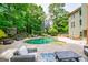 A view of the pool, patio furniture, and treehouse from the backyard at 125 High Bluff Trl, Carrollton, GA 30116