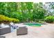 The outdoor patio is furnished with lounge furniture, plus views of the pool and a treehouse at 125 High Bluff Trl, Carrollton, GA 30116