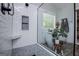 This renovated bathroom features a shower, soaking tub, black fixtures, and wood-look flooring at 125 High Bluff Trl, Carrollton, GA 30116