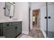 Stylish bathroom with green vanity, white sink, shower with subway tile, and wood-look tile flooring at 125 High Bluff Trl, Carrollton, GA 30116