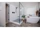 Modern bathroom featuring a glass-enclosed shower and freestanding tub at 125 High Bluff Trl, Carrollton, GA 30116