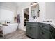 Stylish bathroom with olive green vanity, marble countertop, and soaking tub at 125 High Bluff Trl, Carrollton, GA 30116