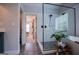 Bright bathroom features a frameless glass shower, soaking tub, and wood-look tile flooring at 125 High Bluff Trl, Carrollton, GA 30116