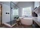 Modern bathroom featuring a shower, soaking tub, black fixtures, and wood-look flooring at 125 High Bluff Trl, Carrollton, GA 30116