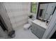 Charming bathroom with a decorative mirror, sleek vanity, and a shower with stylish striped curtains at 125 High Bluff Trl, Carrollton, GA 30116