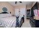Comfortable bedroom featuring a striped bedspread, ceiling fan, and lots of natural light at 125 High Bluff Trl, Carrollton, GA 30116