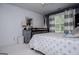 Light-filled bedroom with stylish striped curtains and gray dresser, providing comfort and charm at 125 High Bluff Trl, Carrollton, GA 30116
