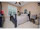 Cozy bedroom featuring a comfortable bed, a large window, and a ceiling fan for added comfort at 125 High Bluff Trl, Carrollton, GA 30116